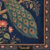 Traditional Indian Pichwai peacock artwork with lotus flowers on royal blue background, decorative floral border, elegant wall art design for home décor.