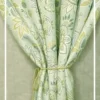 Light green floral curtain with elegant paisley pattern tied with rope tieback, perfect for living room and bedroom home decor