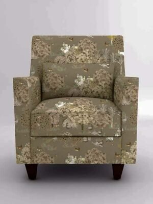 Upholstered accent armchair with beige and olive botanical animal print fabric, square arms, cushioned seat, and wooden legs in a studio setting