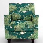 Luxury emerald green forest wildlife print upholstery fabric on accent chair with trees and animals, premium sofa and cushion upholstery for elegant living room interiors
