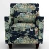Luxury botanical forest print upholstery fabric on accent chair with deer and foliage motifs, premium sofa and cushion upholstery for elegant living room interiors