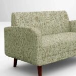 Botanical print upholstery fabric in soft green tones with delicate foliage and wildlife motifs, premium sofa and cushion fabric for elegant interiors