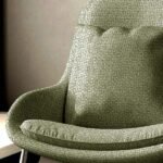 Light sage green textured upholstery fabric with subtle woven pattern, premium sofa and cushion fabric for elegant modern interiors