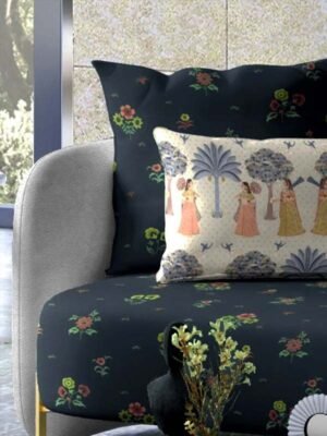 Dark floral upholstered armchair with vintage botanical fabric and decorative cushion featuring traditional folk art women illustration in an elegant living room setting