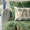 Green ikat patterned upholstery fabric with coordinating printed cushion, premium sofa and cushion fabric for stylish modern interiors