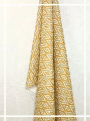Yellow and beige ikat pattern curtain fabric with geometric motifs, ethnic-inspired designer curtains for modern Indian interiors.