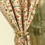 Traditional floral printed curtain fabric with red and green Persian motifs on beige cotton base, elegant decorative drapery fabric for living room and bedroom interiors