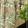 Ottoman Persian inspired curtain fabric with intricate floral and ornamental motifs in green and maroon tones, luxury traditional curtains for elegant interiors.