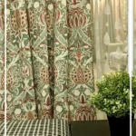 Ottoman Persian inspired curtain fabric with intricate floral and ornamental motifs in green and maroon tones, luxury traditional curtains for elegant interiors.