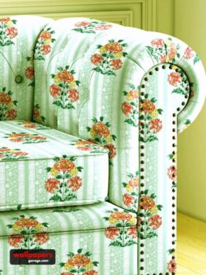 Vintage floral sofa upholstery fabric in pastel green with orange and yellow flower motifs, striped pattern, and classic rolled arm sofa design for elegant living room interiors.