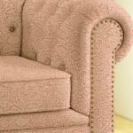 Luxury blush pink floral sofa upholstery fabric with jacquard texture and classic nailhead trim, premium upholstered armchair fabric for elegant living room interiors