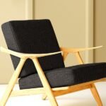 Modern black textured sofa upholstery fabric on wooden accent chair, premium cushion and sofa fabric for contemporary living room interiors