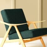 Modern upholstered lounge chair with deep green textured upholstery fabric and solid wooden frame, showcasing premium sofa and chair upholstery fabric for luxury living room interiors