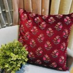 Luxury embroidered floral cushion cover fabric in deep maroon, premium upholstery textile with handcrafted detailing for elegant interiors