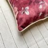 Luxury burgundy floral cushion cover fabric with soft blush roses and delicate botanical detailing, styled for elegant premium interiors.