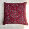 Luxury maroon floral cushion cover fabric with intricate teal and ivory botanical motifs, styled for elegant premium interiors.