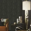 Luxury dark botanical pattern wallpaper with embossed fan-leaf motifs in deep charcoal and antique gold tones, designed for premium interior walls.
