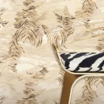 Roberto Cavalli Volume 9 luxury embossed wallpaper with abstract palm leaf design in warm gold and beige tones on a textured stone-effect background