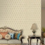 Roberto Cavalli Volume 9 luxury wallpaper with iconic RC monogram chain pattern in warm champagne gold on soft ivory, ideal for premium interiors