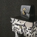 Dark charcoal textured luxury wallpaper with subtle metallic grain finish for modern and premium interiors