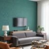 Modern living room interior with teal textured wallpaper accent wall, grey sofa, orange armchairs, wooden side tables and contemporary decor – luxury wallpaper design for stylish home interiors.