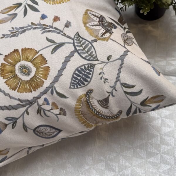 Luxury floral designer fabric in beige with mustard and grey botanical motifs, used for bespoke cushion covers styled on a modern premium bedroom setting.