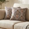 Luxury paisley cushion covers in beige and royal blue with intricate floral motifs, premium woven fabric decorative pillows for elegant living room and bedroom interiors.