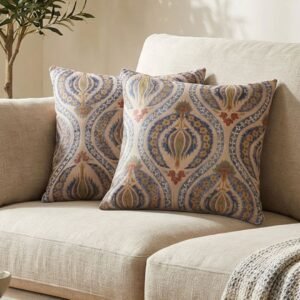 Luxury paisley cushion covers in beige and royal blue with intricate floral motifs, premium woven fabric decorative pillows for elegant living room and bedroom interiors.