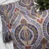 Luxury paisley cushion covers in beige and royal blue with intricate floral motifs, premium woven fabric decorative pillows for elegant living room and bedroom interiors.