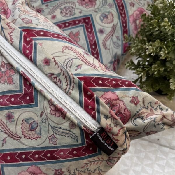 Luxury botanical cushion cover featuring intricate floral motifs in soft sage, blush, and deep crimson with geometric accents, perfect for premium interiors and designer styling.