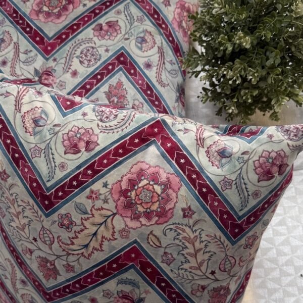 Luxury botanical cushion cover featuring intricate floral motifs in soft sage, blush, and deep crimson with geometric accents, perfect for premium interiors and designer styling.