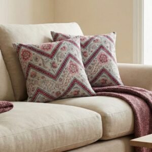Luxury botanical cushion cover featuring intricate floral motifs in soft sage, blush, and deep crimson with geometric accents, perfect for premium interiors and designer styling.