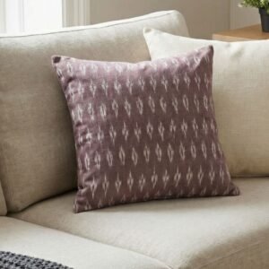 Luxury mauve ikat pattern cushion covers in premium woven fabric, styled on a soft neutral surface with modern décor accents for elegant living room interiors.