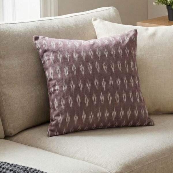 Luxury mauve ikat pattern cushion covers in premium woven fabric, styled on a soft neutral surface with modern décor accents for elegant living room interiors.