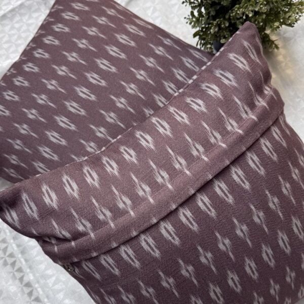 Luxury mauve ikat pattern cushion covers in premium woven fabric, styled on a soft neutral surface with modern décor accents for elegant living room interiors.