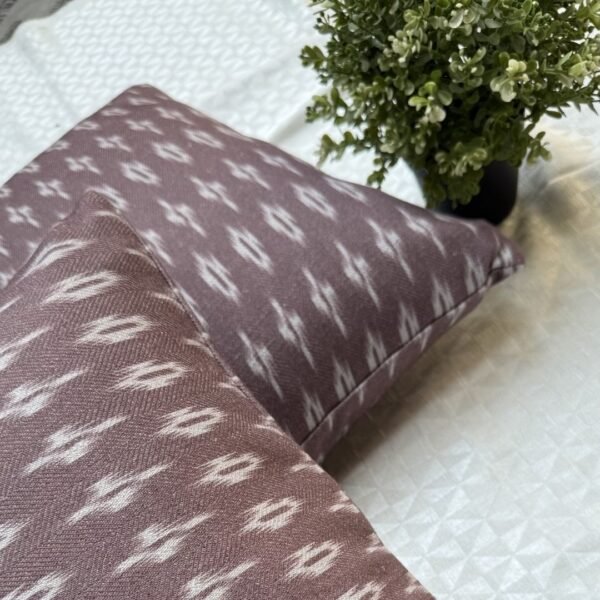 Luxury mauve ikat pattern cushion covers in premium woven fabric, styled on a soft neutral surface with modern décor accents for elegant living room interiors.