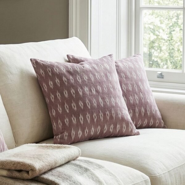 Luxury mauve ikat pattern cushion covers in premium woven fabric, styled on a soft neutral surface with modern décor accents for elegant living room interiors.