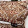 Designer woven cushion cover in warm terracotta and rust tones with cream floral paisley pattern, luxury bespoke pillow for premium living room decor