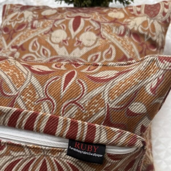 Designer woven cushion cover in warm terracotta and rust tones with cream floral paisley pattern, luxury bespoke pillow for premium living room decor