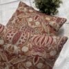 Designer woven cushion cover in warm terracotta and rust tones with cream floral paisley pattern, luxury bespoke pillow for premium living room decor