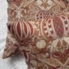 Designer woven cushion cover in warm terracotta and rust tones with cream floral paisley pattern, luxury bespoke pillow for premium living room decor