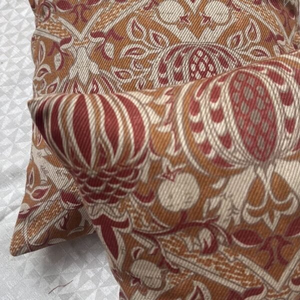 Designer woven cushion cover in warm terracotta and rust tones with cream floral paisley pattern, luxury bespoke pillow for premium living room decor
