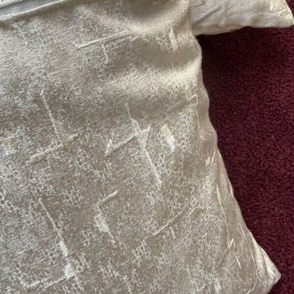 Luxury ivory textured cushion cover in premium designer fabric with subtle geometric weave pattern, styled for modern neutral interiors.