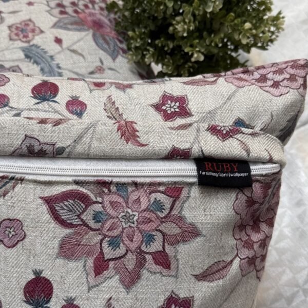 Luxury floral cushion cover in beige woven fabric with pink, burgundy and blue botanical pattern, premium soft furnishing accent for elegant living room and bedroom interiors.