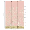 Soft blush pink floral mural wallpaper with delicate white botanical branches and birds, styled in a modern luxury living room with a grey sofa and glass coffee table