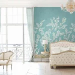 Elegant teal floral mural wallpaper with white botanical branches and birds, styled in a luxury classic bedroom interior with vintage furniture and soft lighting