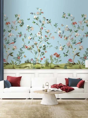 Daisy Bennett floral bird mural wallpaper on soft blue background in elegant bedroom with upholstered bed, pastel cushions and classic wooden side tables