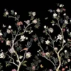 Daisy Bennett mural wallpaper by RUBY featuring delicate floral trees with blossoms and birds on a black background, styled in a modern luxury living room with a white sofa and soft decor