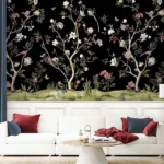 Daisy Bennett mural wallpaper by RUBY featuring delicate floral trees with blossoms and birds on a black background, styled in a modern luxury living room with a white sofa and soft decor