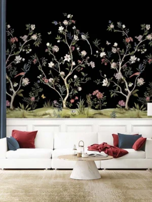 Daisy Bennett mural wallpaper by RUBY featuring delicate floral trees with blossoms and birds on a black background, styled in a modern luxury living room with a white sofa and soft decor
